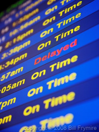 Airport Arrival board display "Delayed" and "On Time"