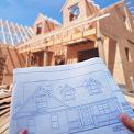 new home construction with blueprints